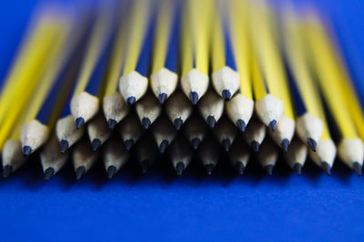 Close-up of colored pencils against blue background