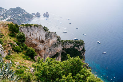 Scenic view of sea and mountains against sky