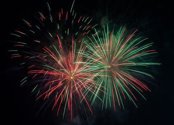 Low angle view of firework display at night