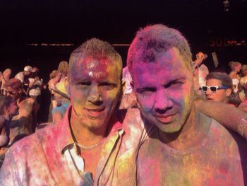 Portrait of young man with multi colored friends