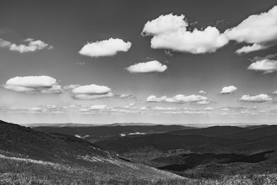 Scenic view of field and mountains against sky