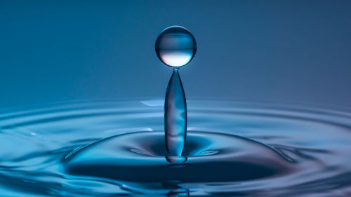 Close-up of water drops on blue background