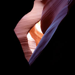 Low angle view of rock formation against black background