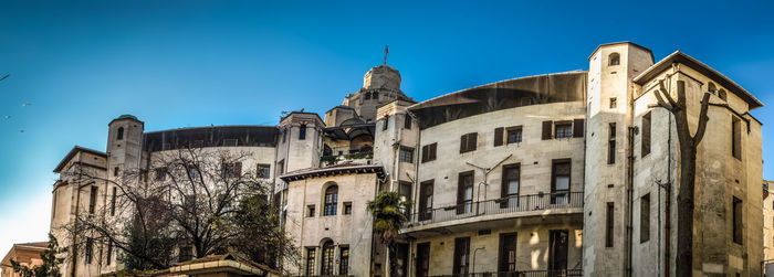 Low angle view of buildings against blue sky