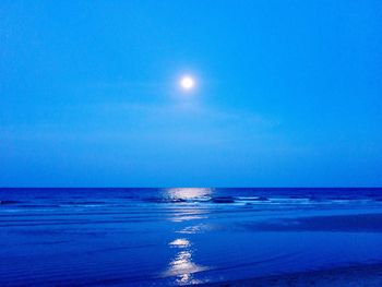 Scenic view of sea against clear blue sky