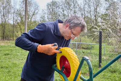 Side view of man exercising on field