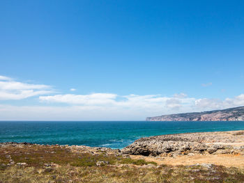 Scenic view of sea against blue sky