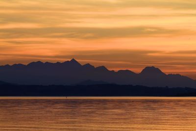 Scenic view of lake against romantic sky at sunset