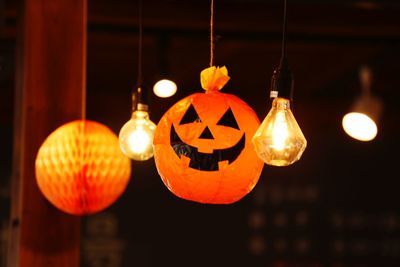 Close-up of illuminated lanterns hanging at night