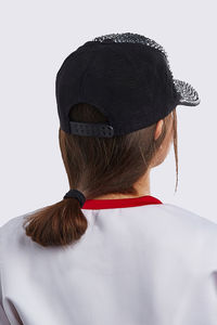 Rear view of woman wearing mask against white background