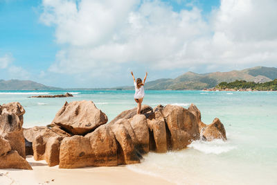 Panoramic shot of rocks on beach against sky