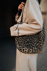 Midsection of woman holding bag