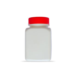 Close-up of red bottle against white background