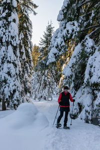 Woman skiing on snow covered land