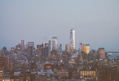 Aerial view of modern buildings in city against clear sky