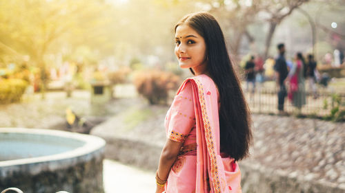 Portrait of smiling woman in sari outdoors