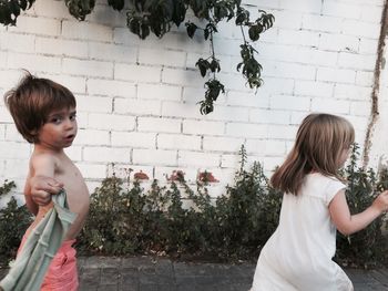 Young woman standing by railing