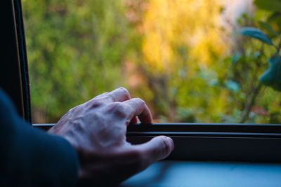 Midsection of man holding mobile phone