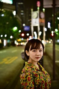 Portrait of young woman standing outdoors