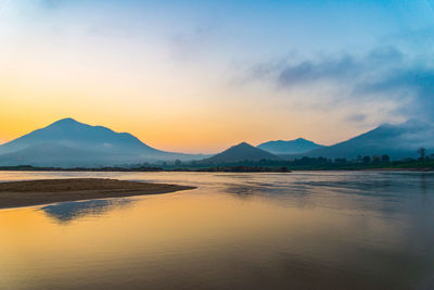 Scenic view of lake against sky during sunset