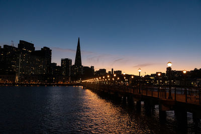 Illuminated city at waterfront