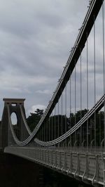 Low angle view of bridge against cloudy sky