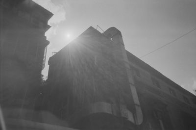 Low angle view of buildings against sky on sunny day