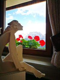 Close-up of statue on window sill at home