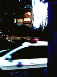 Blurred motion of illuminated car on road in city