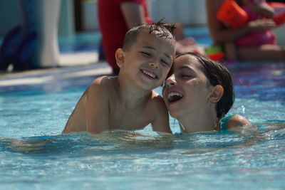 Portrait of happy boy swimming in pool