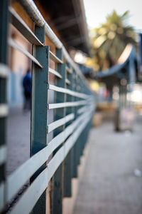 Close-up of railing on footpath