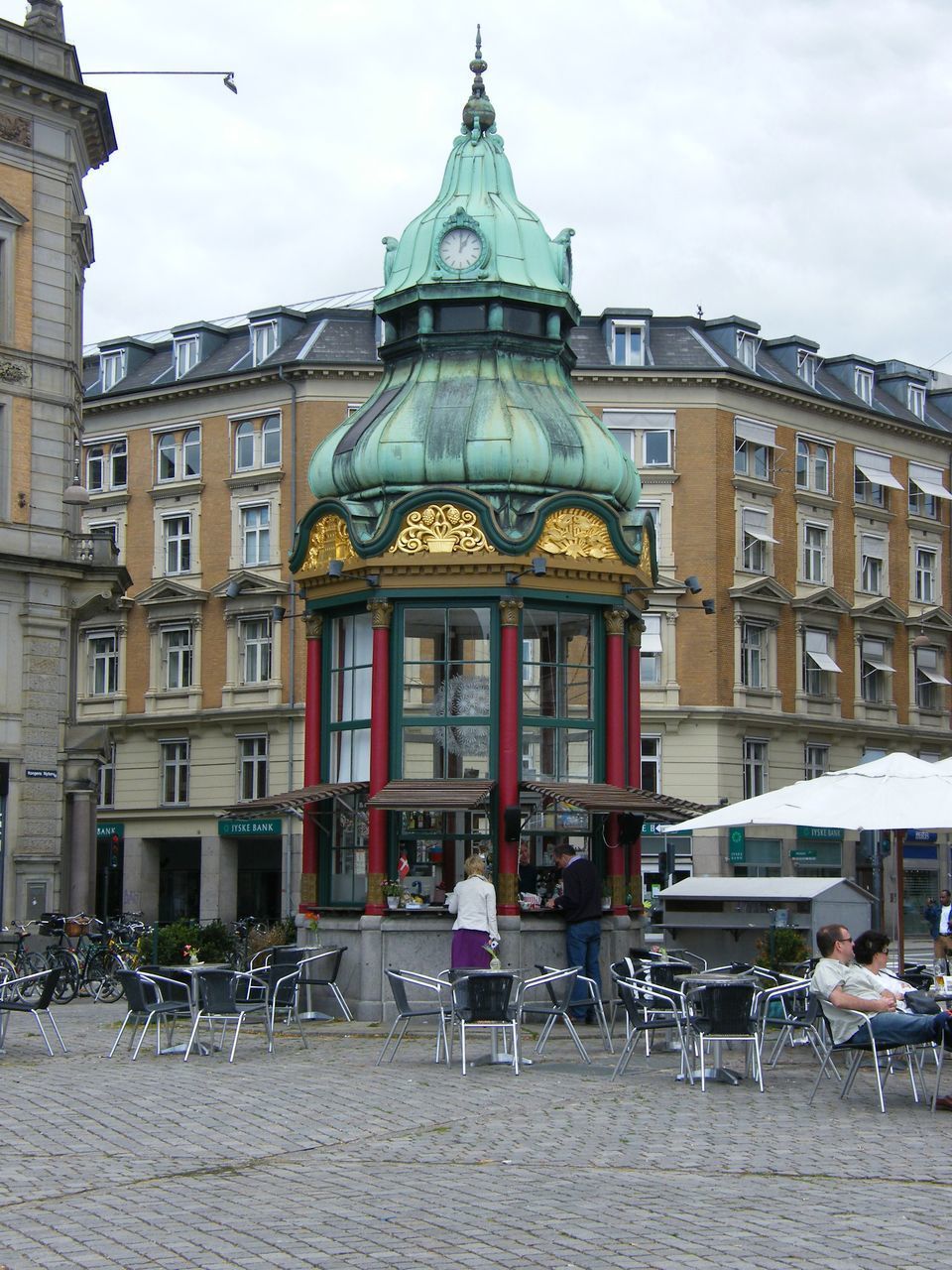 CHAIRS AND TABLE AT SIDEWALK CAFE AGAINST BUILDINGS