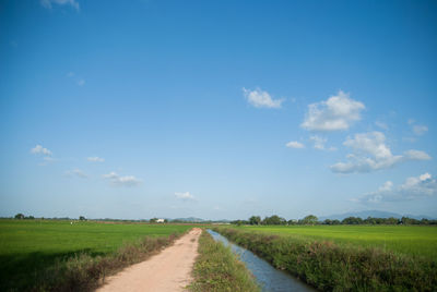 Narrow road along countryside landscape