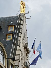 Low angle view of statue against sky