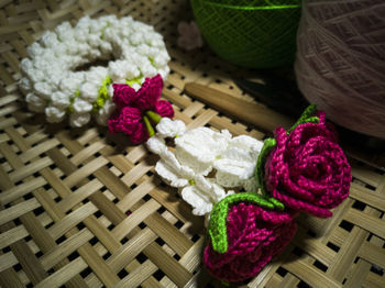 High angle view of pink roses in basket