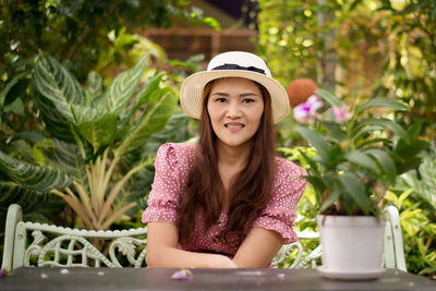 Portrait of a smiling young woman sitting outdoors