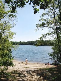Man playing with dog at lake