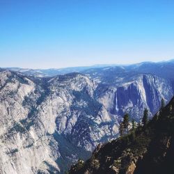 Scenic view of mountains against clear blue sky