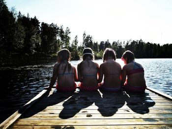 Friends standing on pier