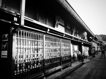 People walking on railroad station platform in city