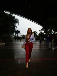 Full length portrait of woman standing outdoors