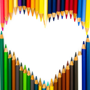 Row of multi colored pencils against white background