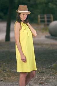 Young woman wearing hat standing outdoors