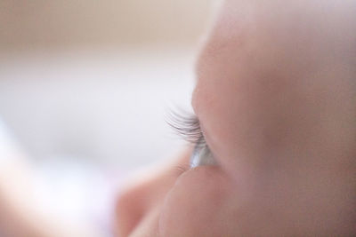 Close-up of baby girl looking away