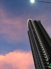 Low angle view of modern buildings against sky at night