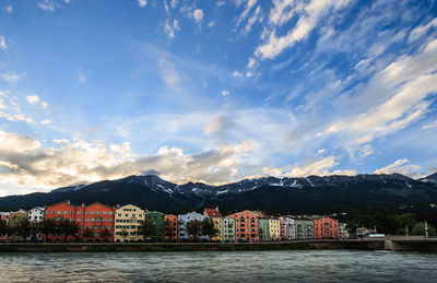 Buildings by town against sky