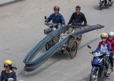 High angle view of people riding motorcycle on road