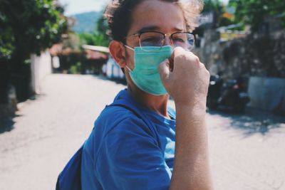 Young man wearing mask standing outdoors