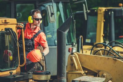 Worker standing by earth mover