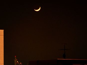 Low angle view of silhouette building against sky at night